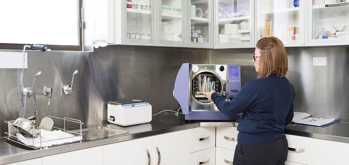 A nurse working with sterilisation equipment